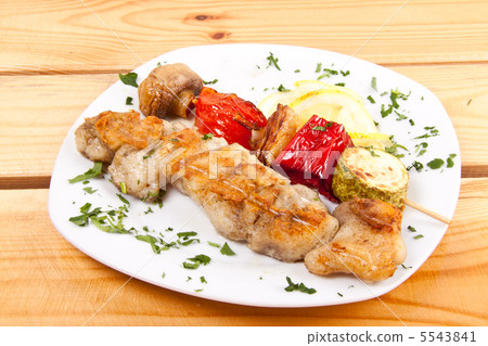 grilled meat pieces on wood sticks with vegetables 5543841
