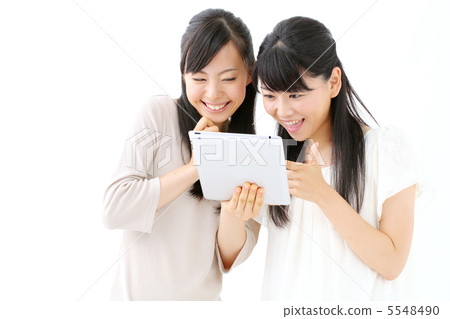 Two girls using iPad Two girls using iPad 5548490