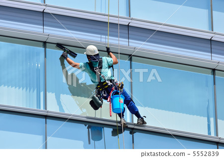 Wiping the window of the building 5552839