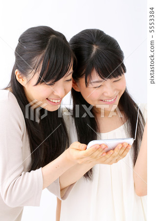 Two girls watching One Seg on smart phone 5553384