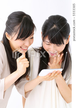 Two girls watching One Seg on smart phone 5553385