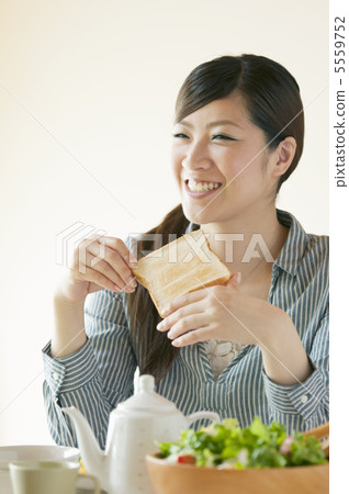A woman eating breakfast A woman eating breakfast 5559752