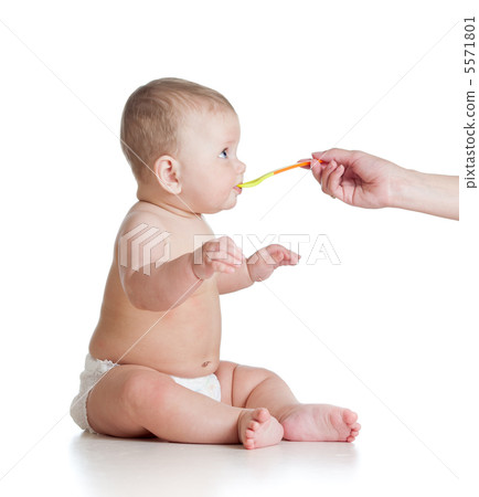 Little baby feeding with a spoon 5571801