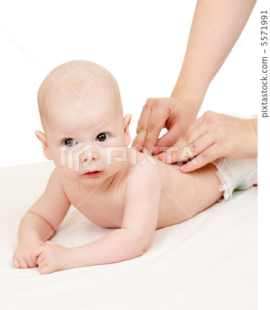 mother massaging her baby boy 5571991