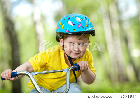 Portrait of a cute child on bicycle Portrait of a cute child on bicycle 5571994