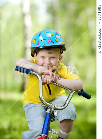 nice kid weared in helmet on bicycle nice kid weared in helmet on bicycle 5571995