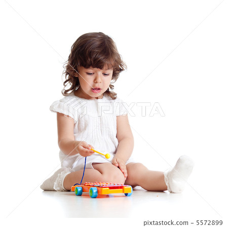 adorable child playing with musical toy 5572899
