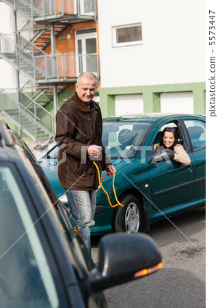 Man helping woman with her broken car Man helping woman with her broken car 5573447
