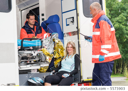 Woman in ambulance with paramedics aid accident 5573903
