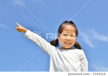 Girl pointing in the blue sky 5593018