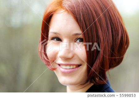 Closeup portrait of beautiful woman with red hair Closeup portrait of beautiful woman with red hair 5599853