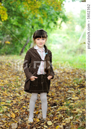 Portrait of adorable child girl in autumn forest 5602362