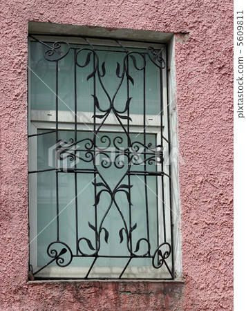 black metal forged carved lattice at a  white window 5609811