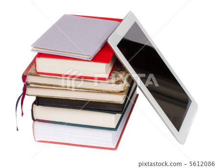 pile of books with modern tablet PC 5612086