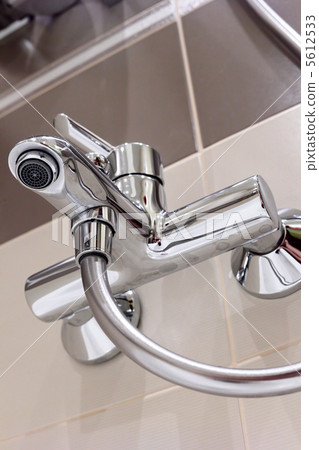 Modern designer tap and shower in bathroom. 5612533