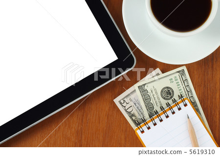 Tablet pc, notepad, pen, money and cup of coffee on wooden background Tablet pc, notepad, pen, money and cup of coffee on wooden background 5619310