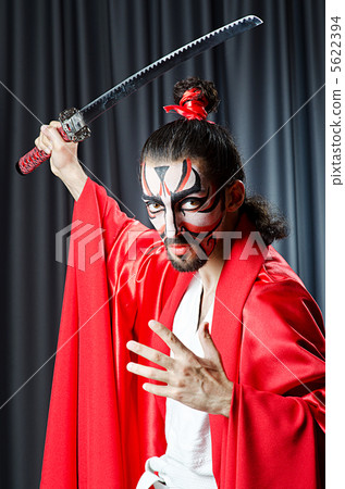 Man with face mask and sword 5622394