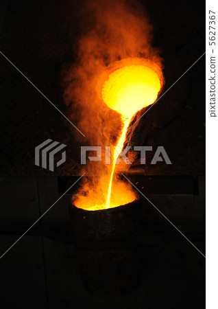 Foundry - molten metal poured from ladle for casting Foundry - molten metal poured from ladle for casting 5627367