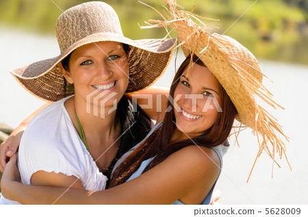 Mother and daughter hugging outdoors summer teen Mother and daughter hugging outdoors summer teen 5628009