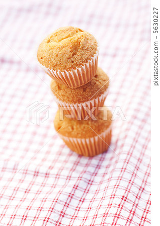 three muffins on plaid fabric three muffins on plaid fabric 5630227
