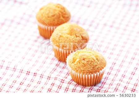 three muffins on plaid fabric three muffins on plaid fabric 5630233