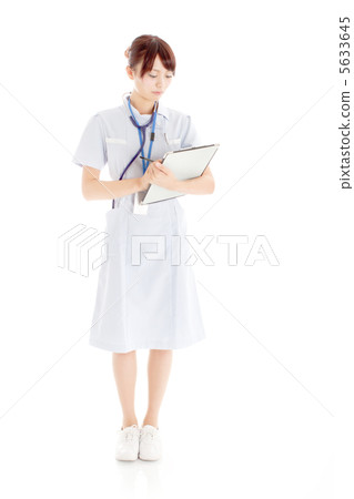 Young nurse seriously writing a questionnaire Young nurse seriously writing a questionnaire 5633645