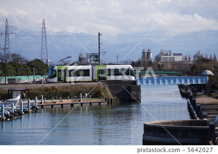 Toyama Light Rail and Tateyama Mountain Range 5642027