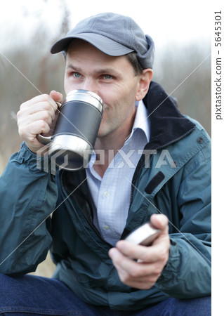 Man drinking tea outdoors 5645301