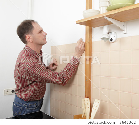 Marking the holes on the wall 5645302