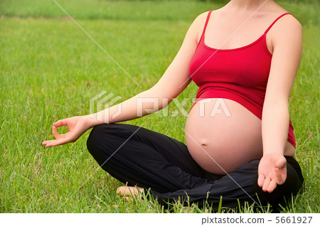 pregnant woman meditating in nature, practice yoga 5661927