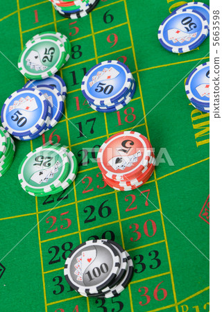 Gaming chips on the green cloth Gaming chips on the green cloth 5663598