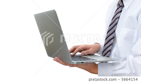 A businessman operating a laptop computer A businessman operating a laptop computer 5664154