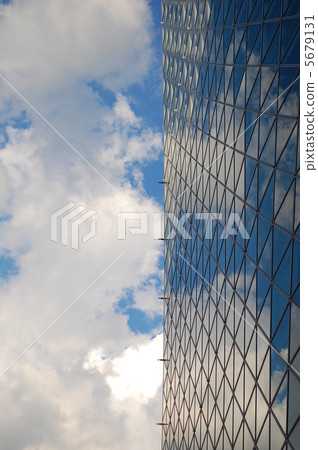 The blue sky reflected in the glass building 5679131
