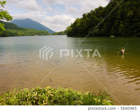 A person who fishes in the hot lake A person who fishes in the hot lake 5680465