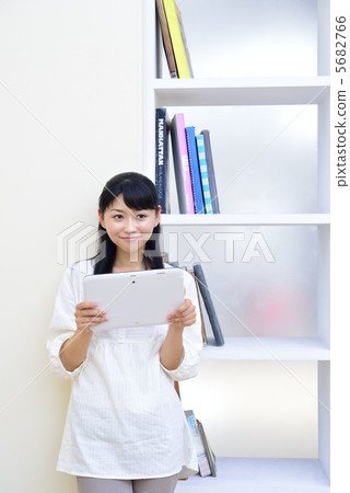 A young woman who enjoys the Internet with a tablet PC 5682766