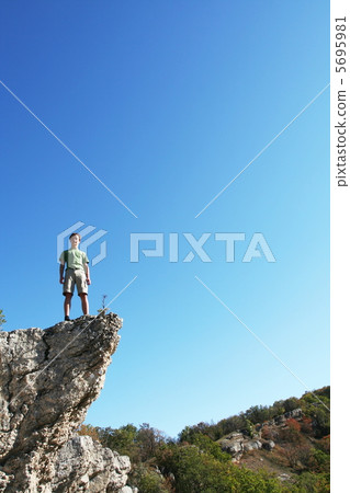 Boy on the cliff 5695981