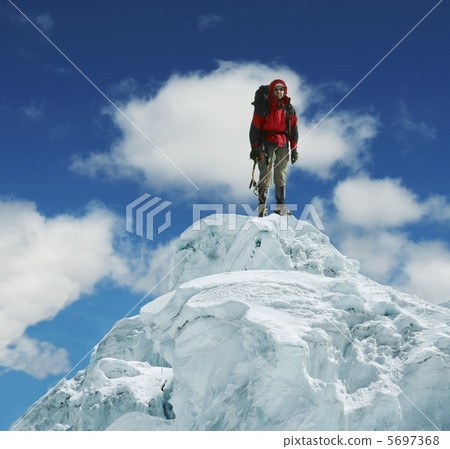Climber on peak Climber on peak 5697368