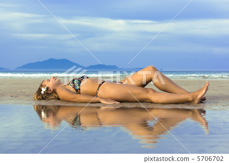 Reflection of young woman on the beach Reflection of young woman on the beach 5706702
