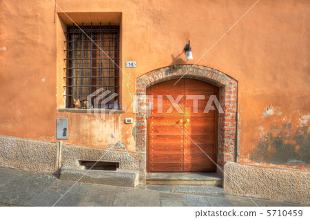 Wooden door and window with bars in Saluzzo. Wooden door and window with bars in Saluzzo. 5710459