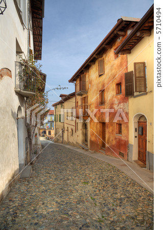 Narrow paved street among houses in Saluzzo, Italy. 5710494