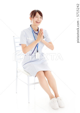A young nurse laughing very happily A young nurse laughing very happily 5715242