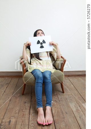 A woman holding a radiation mark 5726270