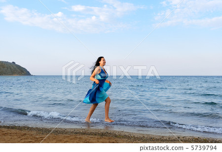 The woman runs on sea coast 5739794