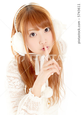 一個穿著秋冬裝的女孩靜靜地把食指放在嘴上 5743611