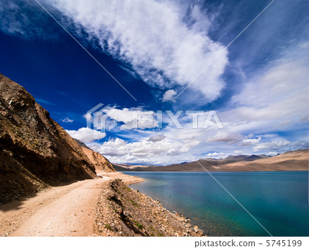 Road going along high mountain lake under blue cloudy sky. Himal Road going along high mountain lake under blue cloudy sky. Himal 5745199