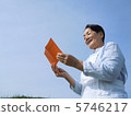 Senior woman looking into pension notebook 5746217