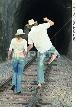 Couple on train tracks 5760419