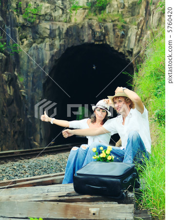Couple on train tracks 5760420