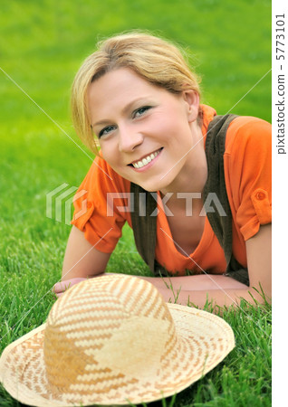 Young woman laying on the grass Young woman laying on the grass 5773101