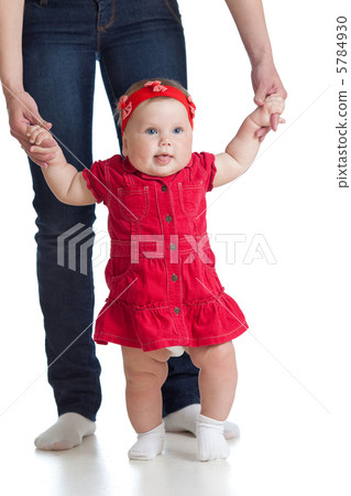 little baby girl doing first step with help of mother 5784930